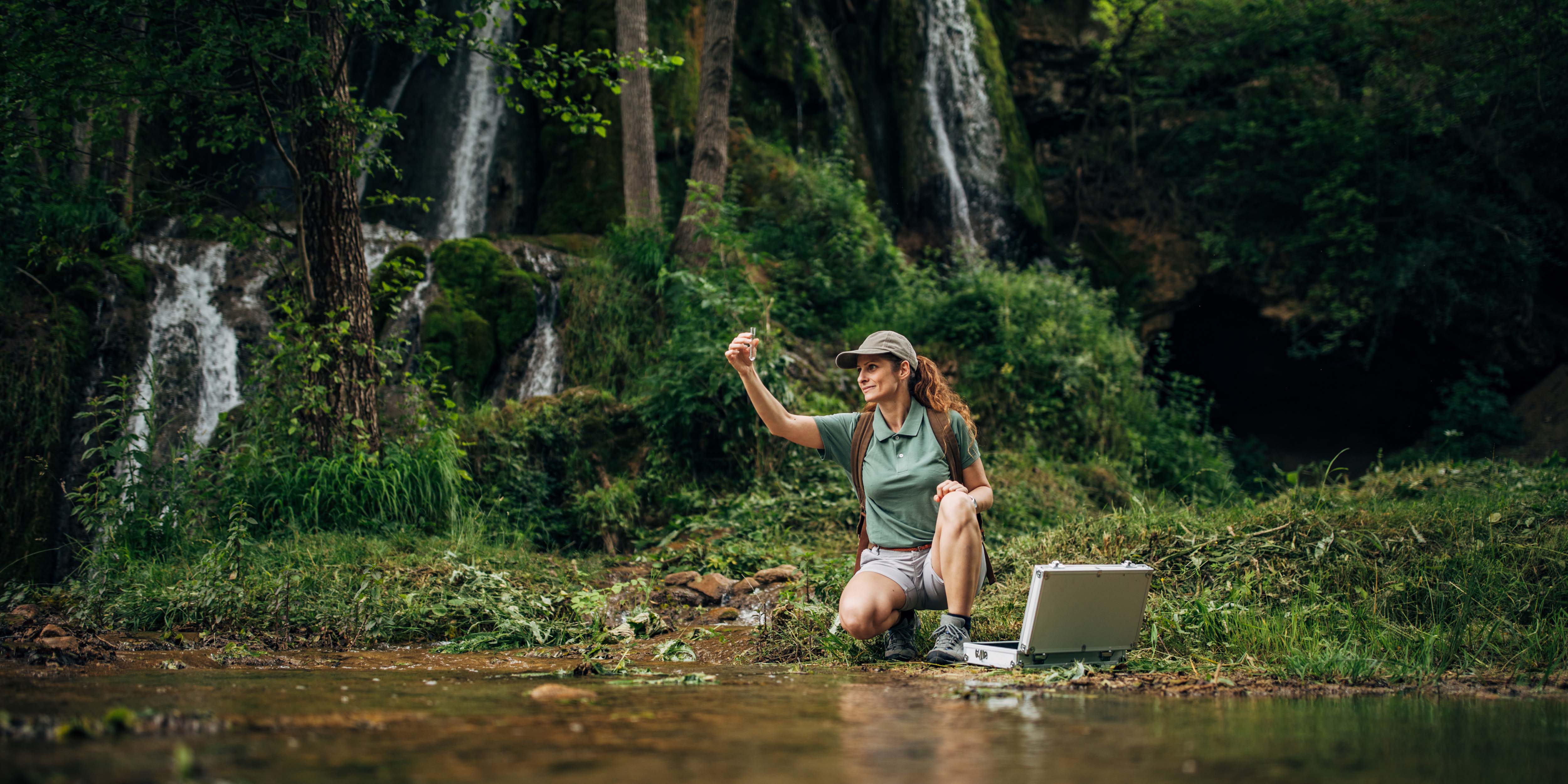 woman testing water quality in river